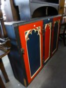 VICTORIAN GOTHIC PAINTED PINE DWARF CUPBOARD, ENCLOSED BY FOLDING DOORS WITH FANCY ARCHED PANELS AND