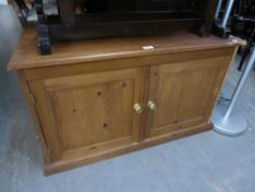 A LOW TWO DOOR PINE CUPBOARD