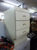 A WHITE FINISH SMALL CHEST OF THREE SHORT DRAWERS
