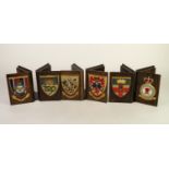THREE PAIRS OF MID TWENTIETH CENTURY OAK BOOK FORM BOOK ENDS, EACH APPLIED WITH PAINTED MILITARY
