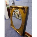LARGE OVAL BEVELLED EDGE WALL MIRROR, IN RECTANGULAR GILT FRAME, WITH ROCOCO EMBOSSED CORNERS