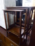 A NEST OF THREE MAHOGANY OBLONG COFFEE TABLES, ON SLENDER, CURVED, SQUARE TAPERING LEGS