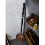 AN ANTIQUE COPPER BED WARMING PAN WITH LONG TURNED WOOD HANDLE
