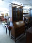 1920?s  OAK BUREAU BOOKCASE, THE SUPERSTRUCTURE BOOKCASE ENCLOSED BY TWO PANE PANEL GLAZED DOORS,