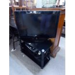 LG FLAT SCREEN TELEVISION ON BLACK GLASS THREE TIER STAND, WITH SKY BOX; TOSHIBA VIDEO AND LG BLU-