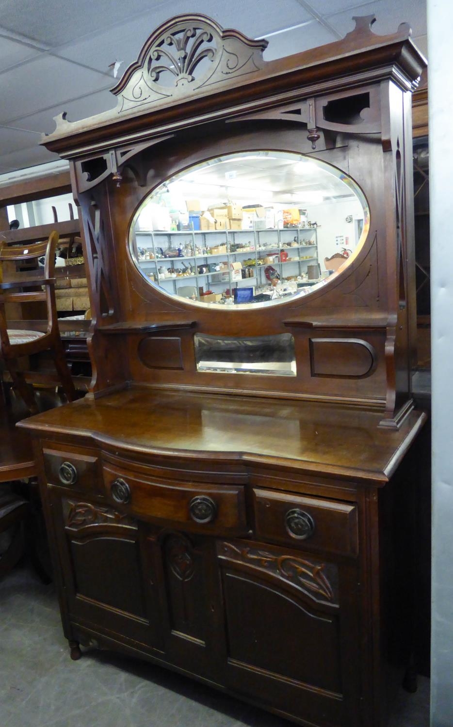 AN EARLY 20TH CENTURY CARVED WALNUT SIDEBOARD WITH ELABORATE HIGH CANOPY BACK, WITH OVAL BEVELLED