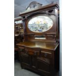 AN EARLY 20TH CENTURY CARVED WALNUT SIDEBOARD WITH ELABORATE HIGH CANOPY BACK, WITH OVAL BEVELLED