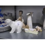 4 LLADRO SPANISH PORCELAIN ORNAMENTS, VIZ A YOUNG BOY SEATED WITH A DOG; A GIRL IN A NIGHTDRESS (