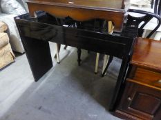 A BLACK GLOSS CONSOLE TABLE, WITH ONE LONG DRAWER, ON END PANEL SUPPORTS