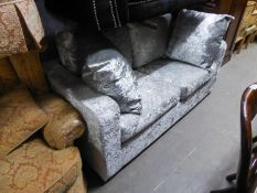 A DOUBLE SOFA BED COVERED IN SILVER CRUSHED VELVET