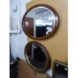 AN INLAID MAHOGANY OVAL WALL MIRROR AND ANOTHER OVAL WALL MIRROR (2)