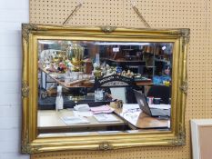 A GOOD QUALITY GILT FRAMED BEVELLED EDGE WALL MIRROR WITH MOULDED DECORATION (FRAME 110cm x 80cm)