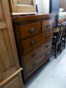 A LATE VICTORIAN CHEST OF TWO SHORT AND THREE LONG DRAWERS ON TURNED FEET