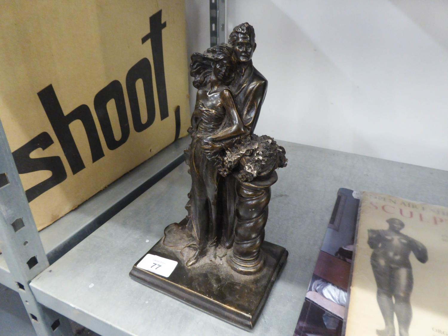 A MODERN BRONZED CASED FIGURE GROUP, MAN AND WOMAN EMBRACING STANDING NEXT TO A PEDESTAL, ON
