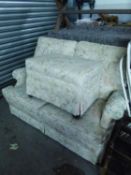 PARKER KNOLL TWO SEATER SETTEE AND MATCHING LARGE RECTANGULAR FOOTSTOOL, COVERED IN GOLD ON WHITE