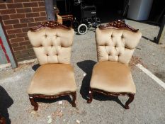 A PAIR OF REPRODUCTION LOW NURSING CHAIRS COVERED IN CREAM FABRIC  (2)