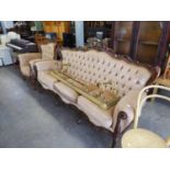 AN ITALIAN CARVED AND PIERCED WALNUT SHOW-FRAMED SUITE OF THREE SEATER SETTEE, A PAIR OF ARMCHAIRS