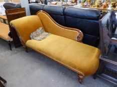 A VICTORIAN CARVED MAHOGANY SHOW-WOOD FRAMED CHAISE LONGUE WITH SINGLE SCROLL END, UPHOLSTERED AND