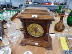 LATE VICTORIAN CARVED MEDIUM OAK MANTEL CLOCK, HAVING EIGHT DAYS MOVEMENT, STRIKING ON A COILED