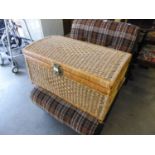 A LARGE WICKER LINEN RECEIVER IN THE FORM OF A TRUNK WITH HINGED DOMED LID