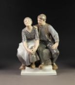 ROYAL COPENHAGEN PORCELAIN GROUP, painted in muted tones and modelled as a couple, seated, on a