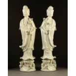 MODERN PAIR OF CHINESE BLANC DE CHINE FIGURES OF GUAN YIN, each modelled holding a lotus and