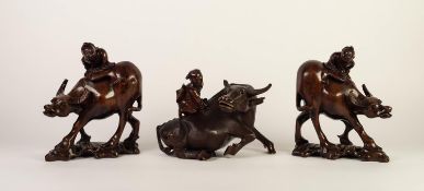 PAIR OF CHINESE LATE QING DYNASTY CARVED WOODEN MODELS OF WATER BUFFALO, each supporting a figure,