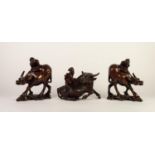 PAIR OF CHINESE LATE QING DYNASTY CARVED WOODEN MODELS OF WATER BUFFALO, each supporting a figure,