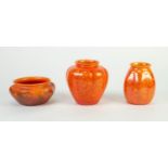 THREE SMALL PIECES OF ROYAL LANCASTRIAN ORANGE VERMILLION GLAZED LOBATED POTTERY, comprising: