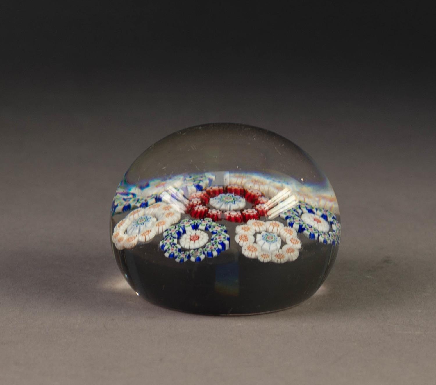 OLD MILLEFIORI GLASS PAPERWEIGHT, containing seven circular flowerheads in coloured canes, 2 ¼? (5.