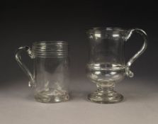 TWO ANTIQUE GLASS TANKARDS WITH LOOSE GEORGIAN COINS IN THE BASES, 5 ¼? (13.3cm) high, the other