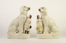 PAIR OF VICTORIAN STAFFORDSHIRE MANTLE DOG POTTERY GROUPS, each heightened in colours and modelled