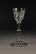 ENGRAVED BALUSTROID WINE GLASS, with funnel shaped bowl, wheel cut with fruiting vines, above a stem