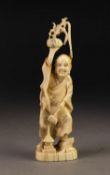 ORIENTAL CARVED IVORY OKIMONO OF A MONK, CARRYING A SCEPTRE AND POTTED PLANT, 5 ½? (14cm) high,
