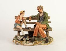 CAPO DIMONTE PORCELAIN GROUP, modelled as a boy and grandfather playing cards, on a gilt scrolled