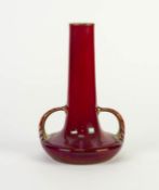 PILKINGTONS RED LUSTRE GLAZED TWO HANDLED POTTERY VASE, of compressed form with loop handles to