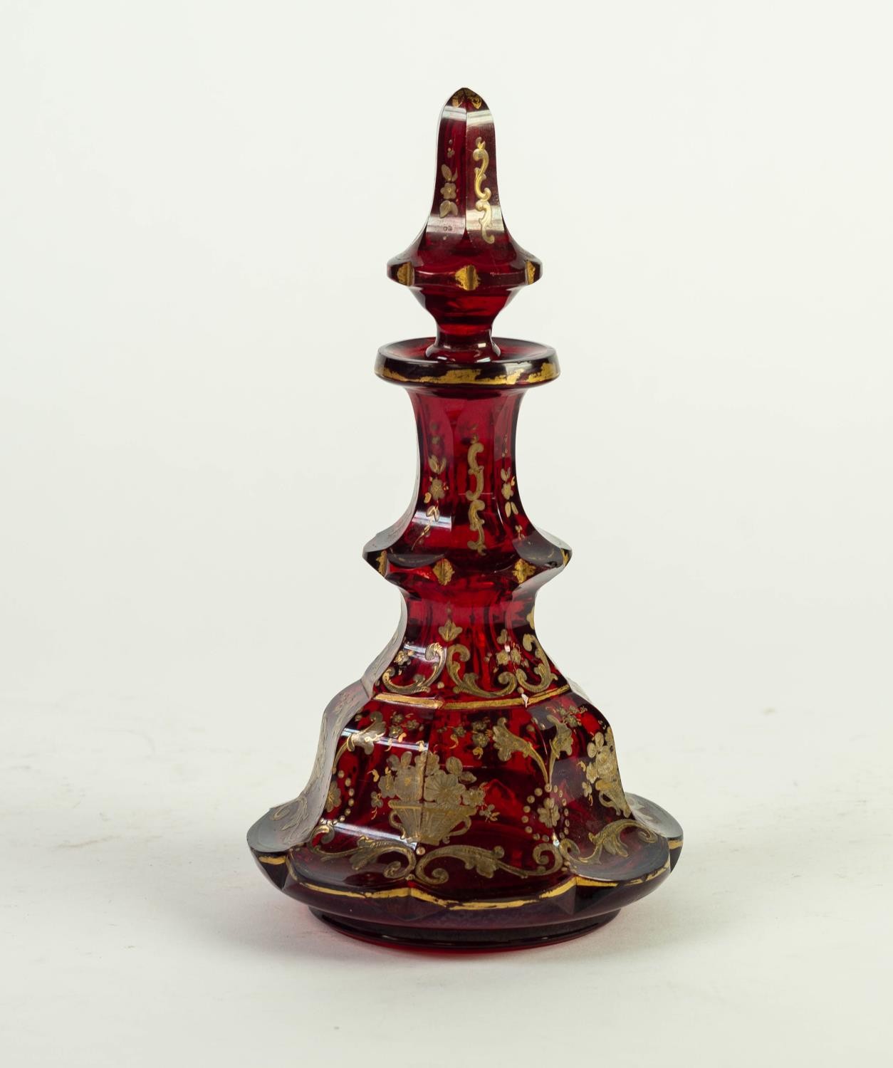 NINETEENTH CENTURY BOHEMIAN RUBY GLASS AND GILT DECANTER AND STOPPER, of tiered, lobated form with