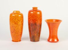 THREE SMALL ROYAL LANCASTRIAN ORANGE VERMILLION GLAZED POTTERY VASES, two of slender ovoid form,