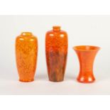 THREE SMALL ROYAL LANCASTRIAN ORANGE VERMILLION GLAZED POTTERY VASES, two of slender ovoid form,