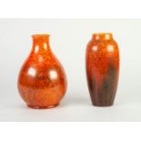 TWO ROYAL LANCASTRIAN ORANGE VERMILLION GLAZED POTTERY VASES, one of footed, baluster form, 9 ½? (