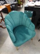 A GOOD QUALITY DARK GREEN SHELL SHAPED BEDROOM CHAIR RAISED ON GOLD COLOURED TV LEGS AND AN OBLONG