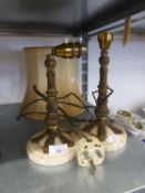 A PAIR OF GILT METAL TABLE LAMPS WITH CREAM MARBLE CIRCULAR BASES AND ONE FABRIC SHADE (3)