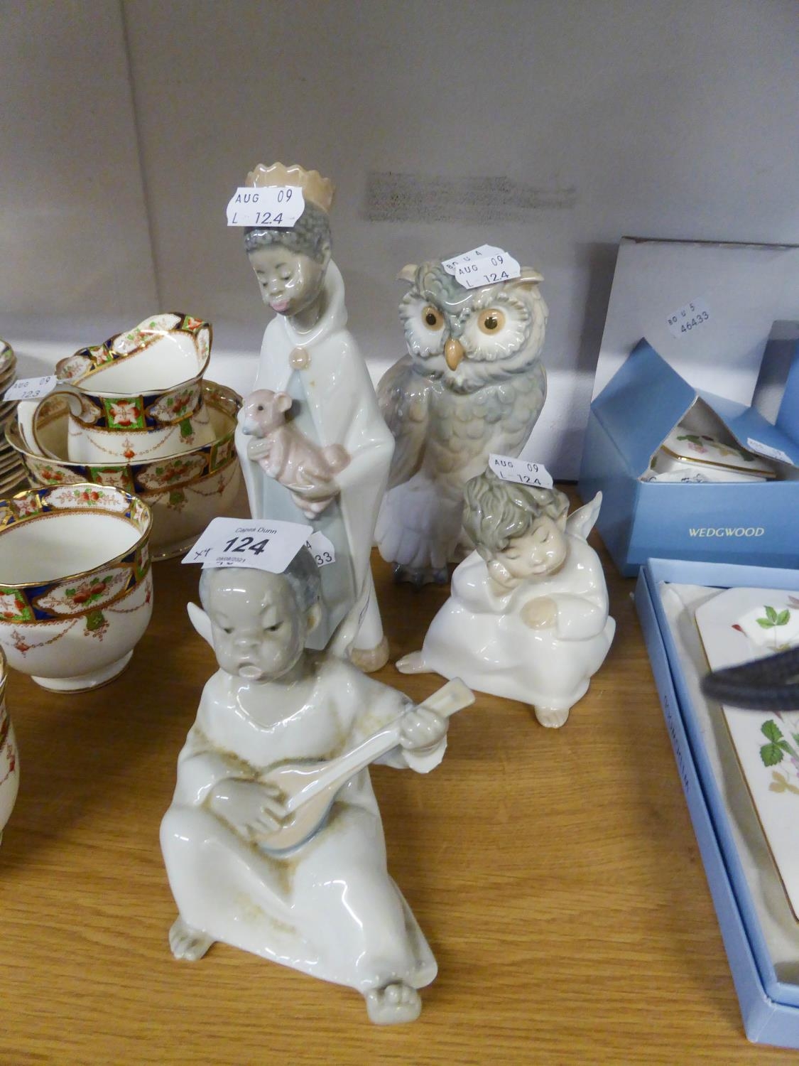 THREE SMALL LLADRO FIGURES COMPRISING; OF TWO CHERUBS AND A BOY HOLDING A LAMB AND A NAO ORNAMENT