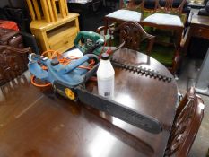 AN ELECTRIC HEDGE TRIMMER AND A CHAIN SAW
