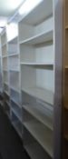 A PAIR OF WHITE MELAMINE SIX TIER OPEN BOOKCASES