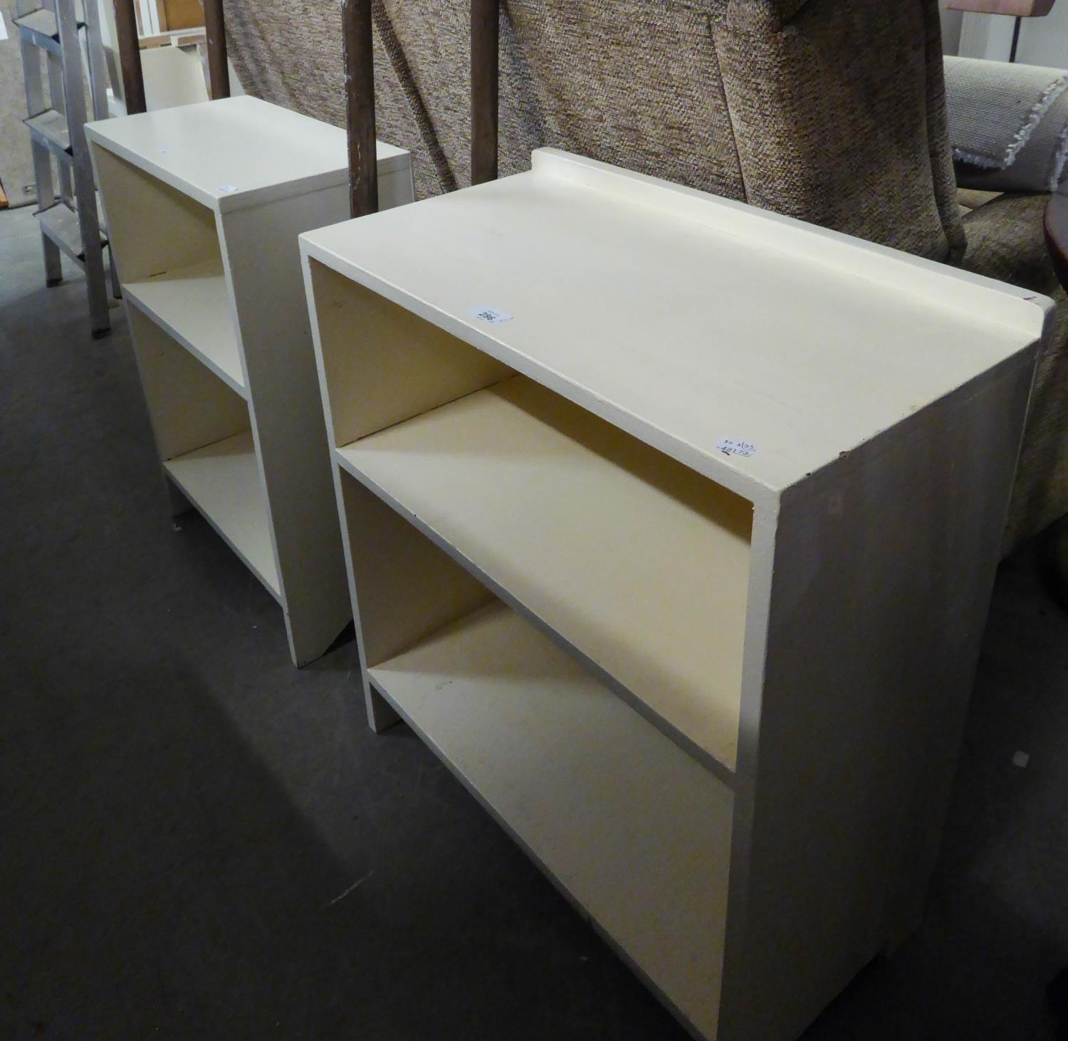 TWO SMALL WHITE PAINTED TWO TIER OPEN BOOKCASES