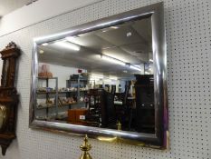 AN OBLONG BEVELLED EDGE WALL MIRROR WITH SILVERED FRAME