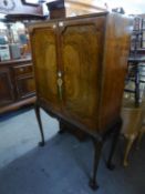 A 1930's WALNUT COCKTAIL CABINET