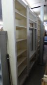 A WHITE PAINTED OPEN BOOKCASE OF SEVEN TIERS, 4? WIDE AND A PAIR OF MATCHING BOOKCASES, 2?6? WIDE (