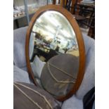 A BEVELLED EDGE OVAL WALL MIRROR, IN MAHOGANY FRAME